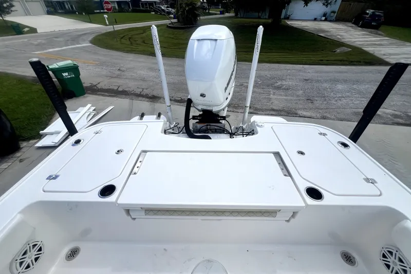 Slide: The Image of 2020 Caymas 26 HB boat with outboard motor and storage compartments. - 83