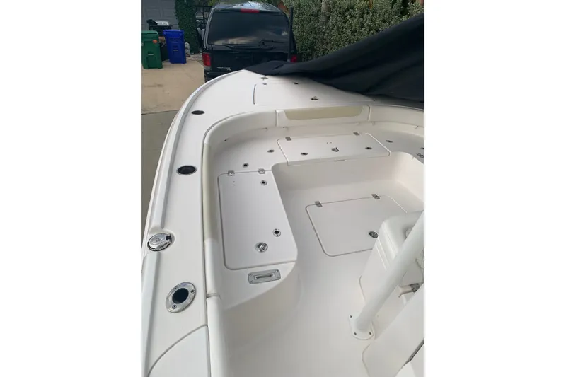 Slide: The Image of 2020 Caymas 26 HB boat deck with storage compartments and sleek design. - 5