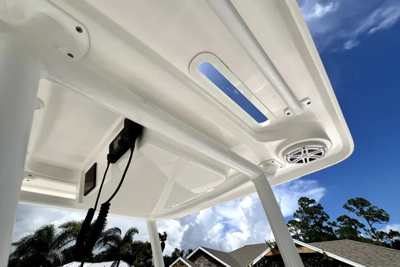 Slide: The Image of 2020 Caymas 26 HB boat T-top with speaker and blue sky background. - 93