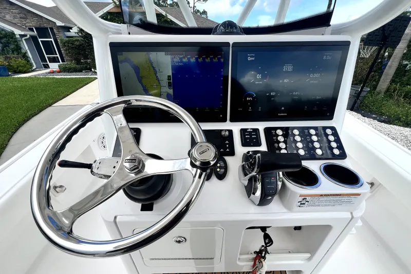 Slide: The Image of Helm of 2020 Caymas 26 HB boat with advanced navigation displays and controls. - 36
