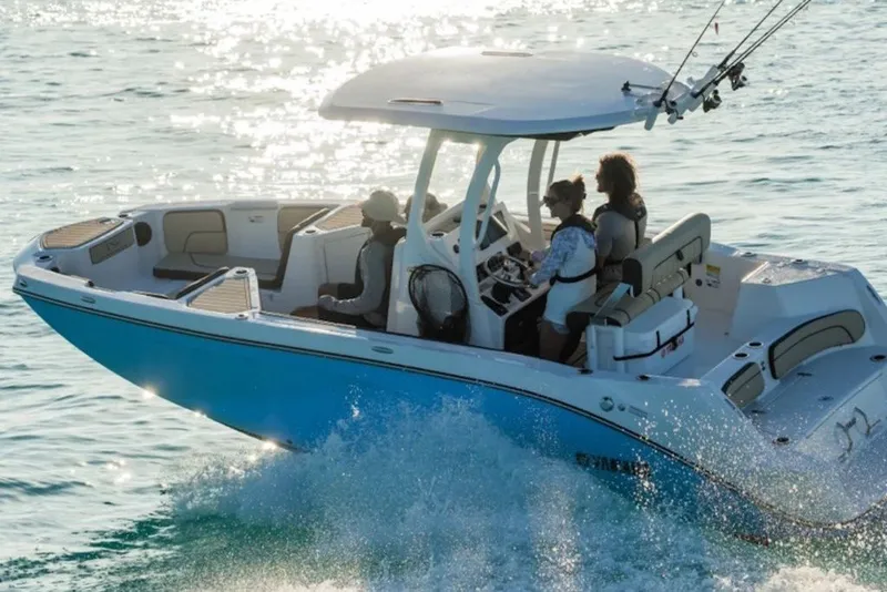 Slide: The Image of 2027 Yamaha Boats 222 FSH Sport E cruising on sparkling water with passengers. - 3