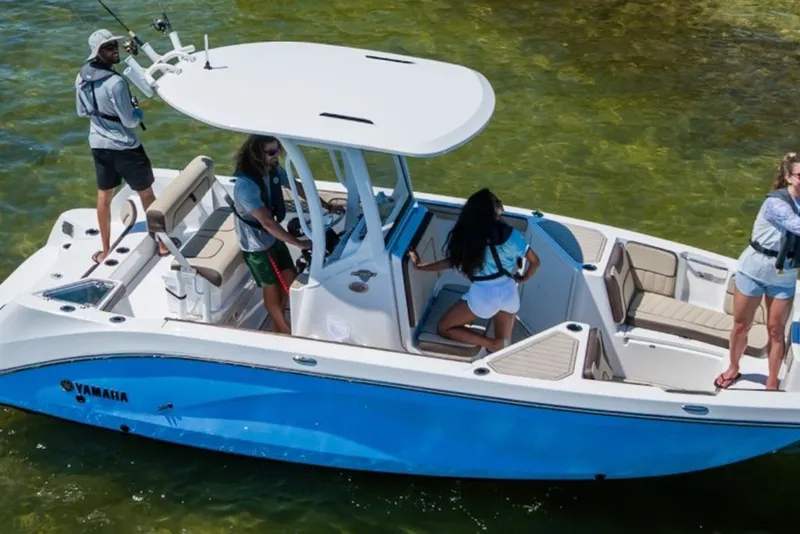 Slide: The Image of 2027 Yamaha Boats 222 FSH Sport E on water with passengers enjoying fishing. - 2