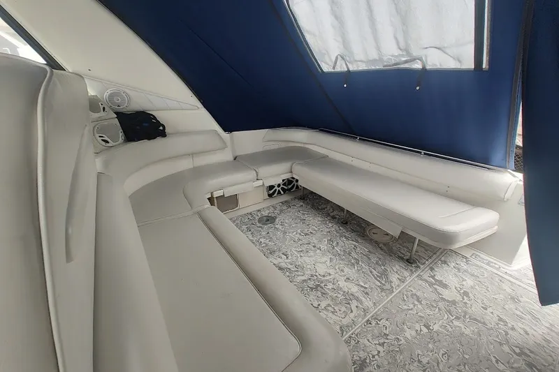 Slide: The Image of Interior of 1998 Sea Ray Sundancer 400 with white seating and blue canopy. - 6