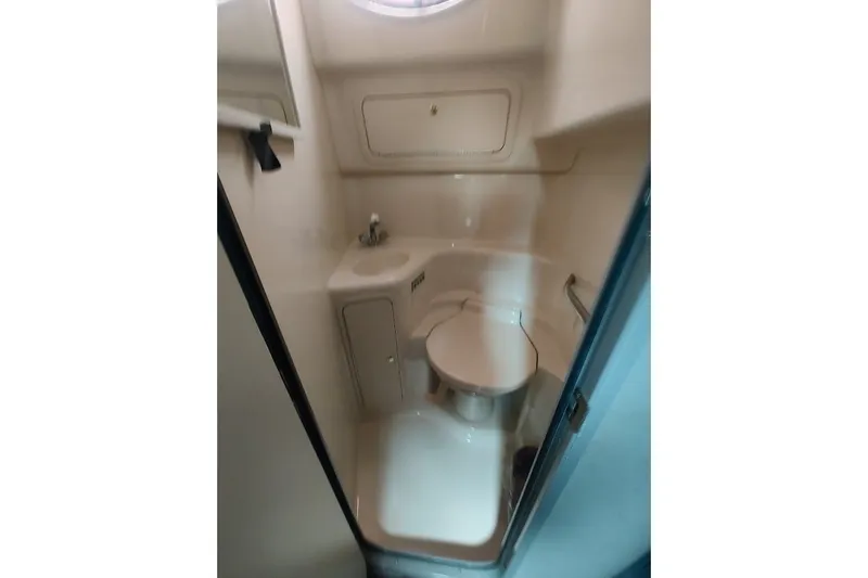 Slide: The Image of 1998 Sea Ray Sundancer 400 bathroom with compact sink and toilet. - 17