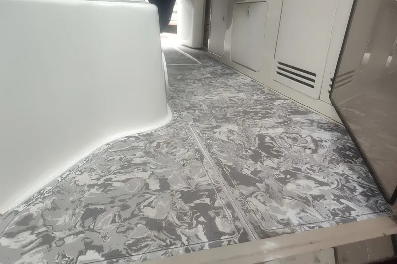 Slide: The Image of Interior flooring of a 1998 Sea Ray Sundancer 400 yacht with a marbled design. - 8