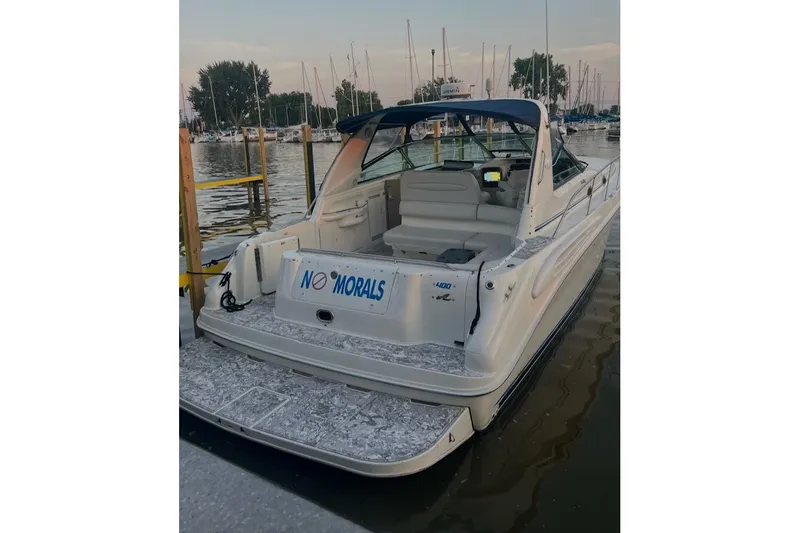 Slide: The Image of 1998 Sea Ray Sundancer 400 docked at marina, rear view with "No Morals" sign. - 5