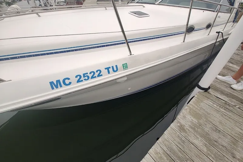Slide: The Image of 1998 Sea Ray Sundancer 400 docked, displaying registration number MC 2522 TU. - 3