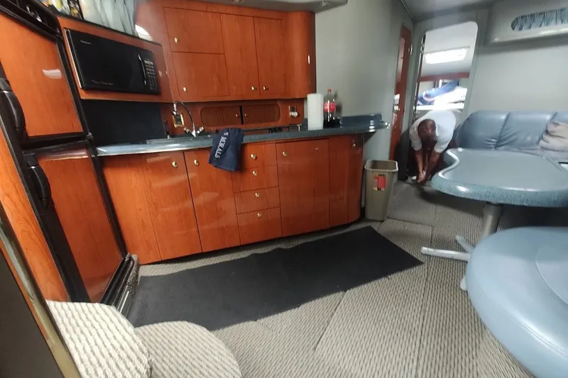 Slide: The Image of Interior of 1998 Sea Ray Sundancer 400 yacht with kitchen and seating area. - 10