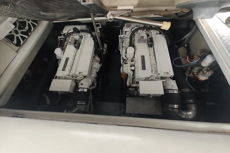 Slide: The Image of Engine compartment of a 1998 Sea Ray Sundancer 400, showcasing dual marine engines. - 18