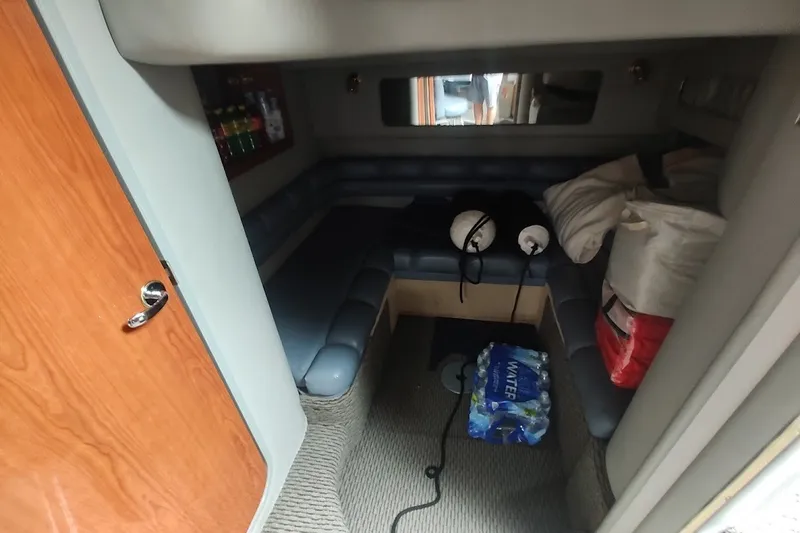 Slide: The Image of Interior cabin of 1998 Sea Ray Sundancer 400 with seating and supplies. - 13