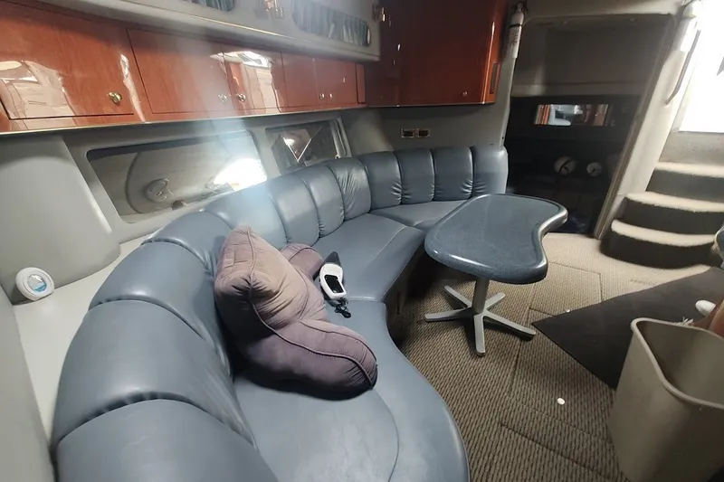 Slide: The Image of Interior of 1998 Sea Ray Sundancer 400 with curved seating and modern table. - 12