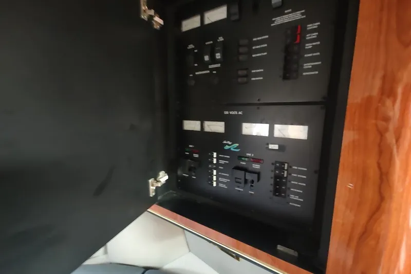 Slide: The Image of Electrical panel inside a 1998 Sea Ray Sundancer 400 yacht, featuring various switches and controls. - 16