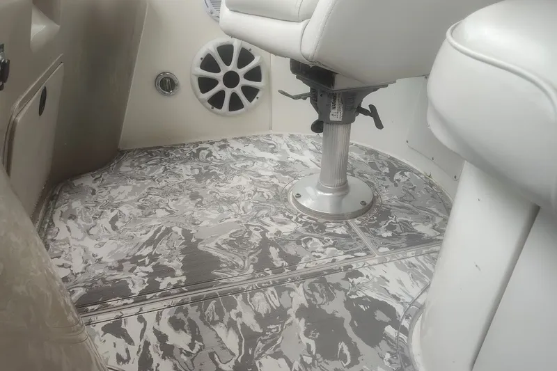 Slide: The Image of Interior of 1998 Sea Ray Sundancer 400 boat with patterned flooring and white seating. - 9