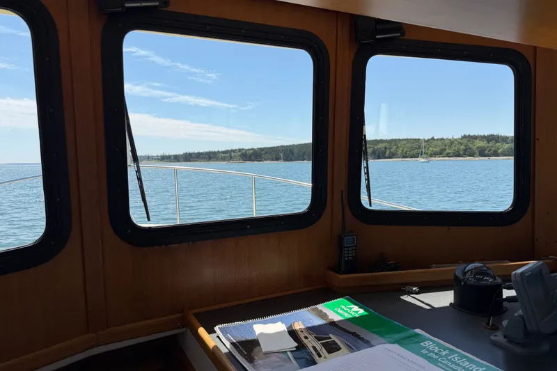 Slide: The Image of Cabin view from a 2001 Nordic Tug 32, overlooking serene waters and distant shoreline. - 40