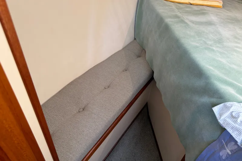 Slide: The Image of Interior of 2001 Nordic Tug 32 with cushioned seating and bed. - 68