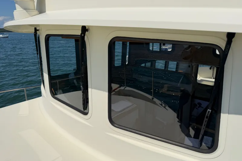 Slide: The Image of 2001 Nordic Tug 32 boat cabin with large windows overlooking the water. - 20