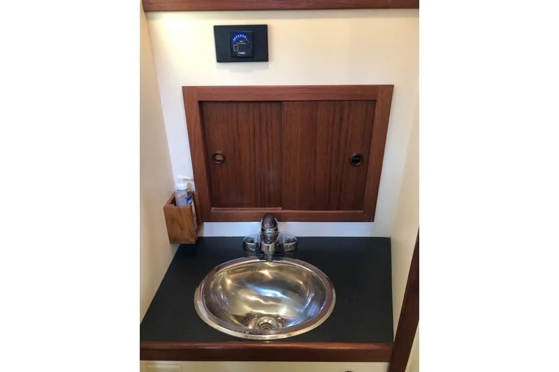 Slide: The Image of 2001 Nordic Tug 32 bathroom sink with wooden cabinet and modern faucet. - 64