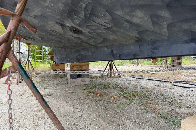Slide: The Image of Bottom view of a 2001 Nordic Tug 32 on blocks, showing hull and supports. - 24