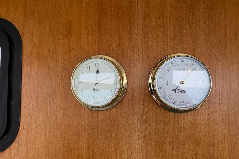 Slide: The Image of Brass clock and barometer on Nordic Tug 32, 2001, wooden panel. - 54