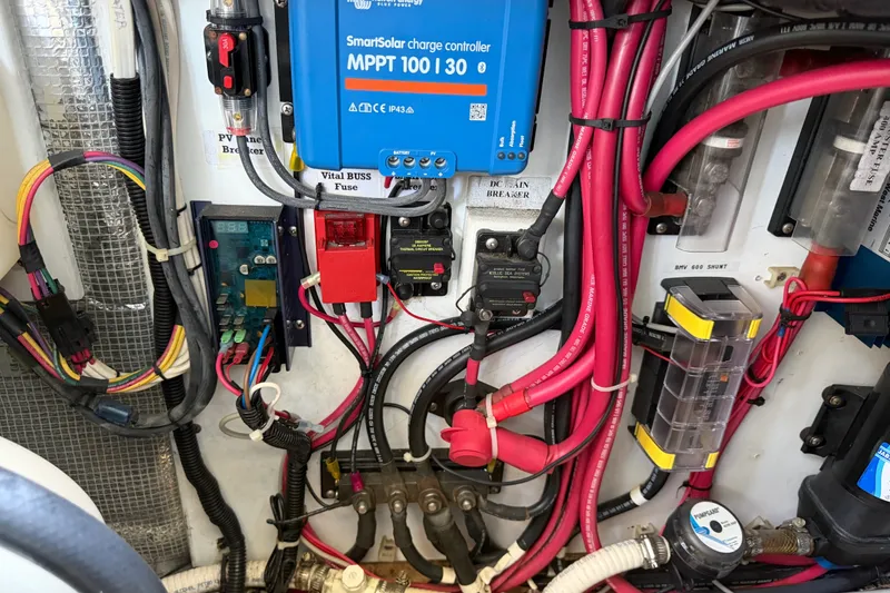 Slide: The Image of Electrical panel of a 2001 Nordic Tug 32 with SmartSolar charge controller and wiring. - 82