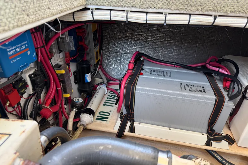 Slide: The Image of Engine compartment of a 2001 Nordic Tug 32, featuring battery and wiring components. - 78