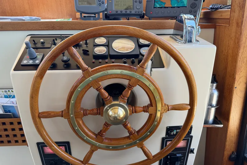 Slide: The Image of Wooden helm of a 2001 Nordic Tug 32 with navigation instruments. - 38