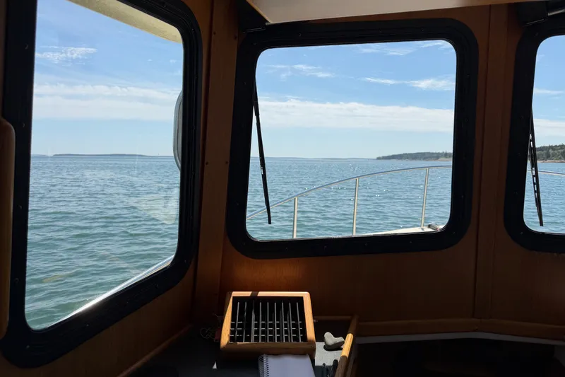 Slide: The Image of View from inside a 2001 Nordic Tug 32, overlooking calm ocean waters. - 39