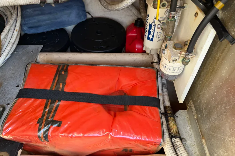 Slide: The Image of Engine compartment of a 2001 Nordic Tug 32 with safety equipment and fuel filters. - 76