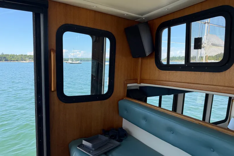Slide: The Image of Interior view of a 2001 Nordic Tug 32 with scenic water and boats outside. - 41
