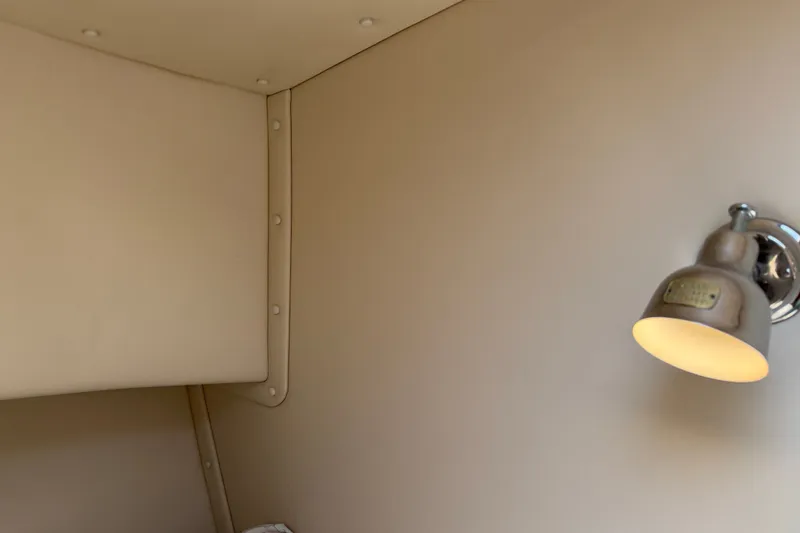 Slide: The Image of Interior of 2001 Nordic Tug 32 with beige walls and a mounted light fixture. - 71