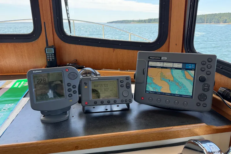 Slide: The Image of Navigation equipment on a 2001 Nordic Tug 32 boat, featuring Raymarine displays. - 45