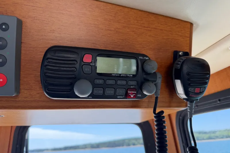 Slide: The Image of VHF radio equipment inside a 2001 Nordic Tug 32 boat cabin. - 50