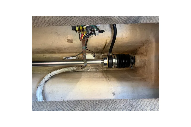Slide: The Image of Engine compartment of a 2001 Nordic Tug 32, showcasing mechanical components and wiring. - 74