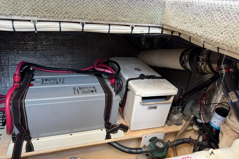Slide: The Image of Engine compartment of a 2001 Nordic Tug 32, featuring battery and wiring components. - 79