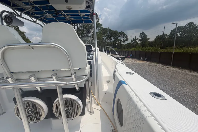 Slide: The Image of 2000 Pro-Line 32 Express boat interior with seating and speakers, parked outdoors. - 13