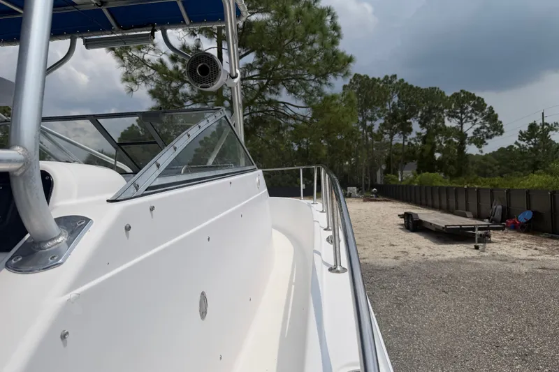 Slide: The Image of 2000 Pro-Line 32 Express boat parked on gravel with trees in background. - 27