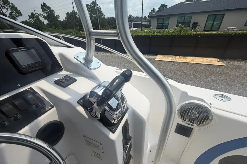 Slide: The Image of Control panel of a 2000 Pro-Line 32 Express boat with steering and throttle. - 21