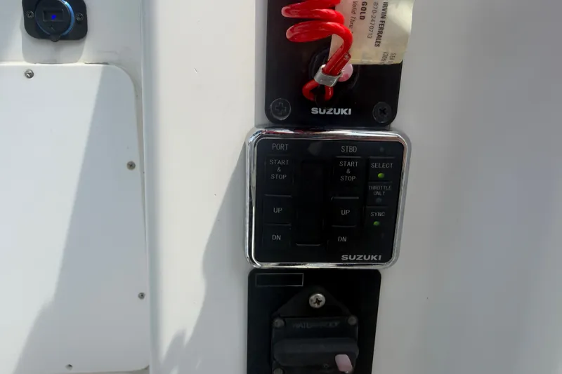 Slide: The Image of Control panel of a 2000 Pro-Line 32 Express boat with Suzuki engine controls. - 22