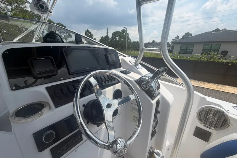 Slide: The Image of Cockpit of 2000 Pro-Line 32 Express boat with steering wheel and control panel. - 15