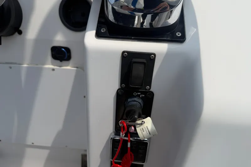 Slide: The Image of Control panel of a 2000 Pro-Line 32 Express boat with ignition switch and key. - 23