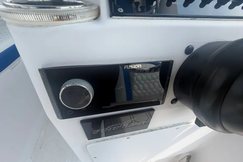 Slide: The Image of Control panel of a 2000 Pro-Line 32 Express boat featuring a Fusion audio system. - 17