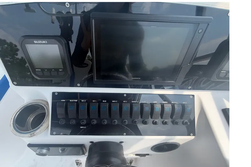 Slide: The Image of Control panel of a 2000 Pro-Line 32 Express boat with Garmin and Suzuki displays. - 20