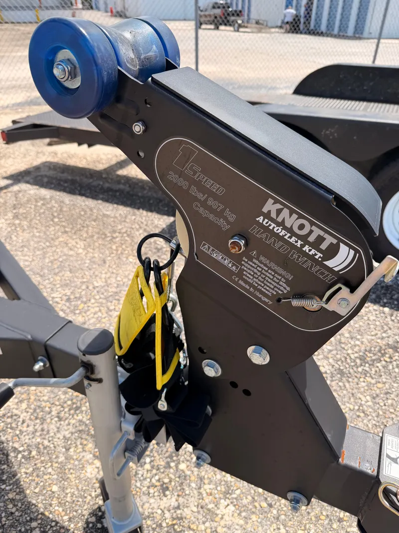 Slide: The Image of Close-up of a boat trailer with a Knott Autoflex kit and blue roller. - 40