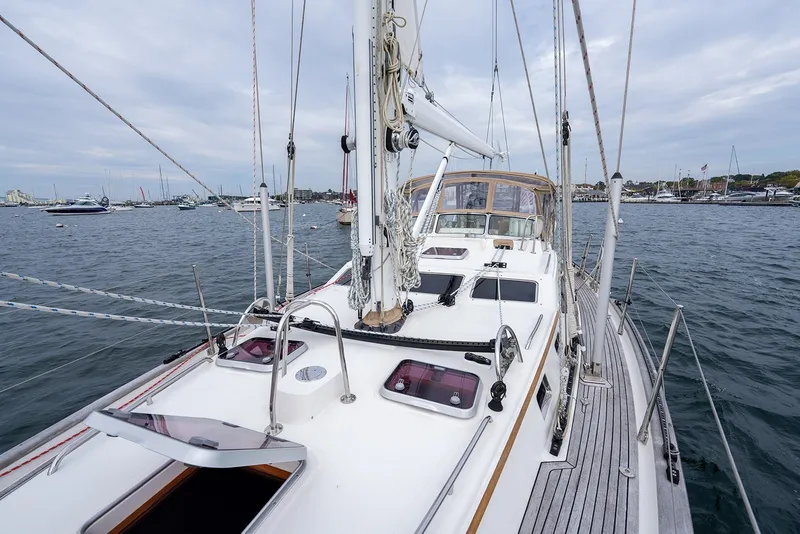 Slide: The Image of 2008 Passport Vista 515 Center Cockpit sailboat on calm waters, showcasing deck and rigging. - 36
