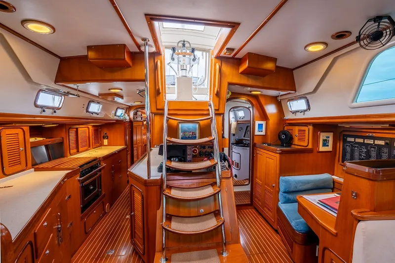 Slide: The Image of Luxurious interior of 2008 Passport Vista 515 Center Cockpit yacht, featuring wood finishes and modern amenities. - 20