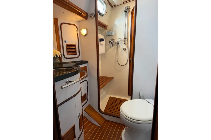 Slide: The Image of Luxurious bathroom in 2008 Passport Vista 515 Center Cockpit yacht, featuring shower and wooden accents. - 18
