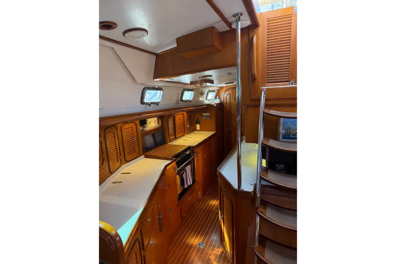 Slide: The Image of Interior of 2008 Passport Vista 515 Center Cockpit yacht with wooden cabinetry and modern amenities. - 15