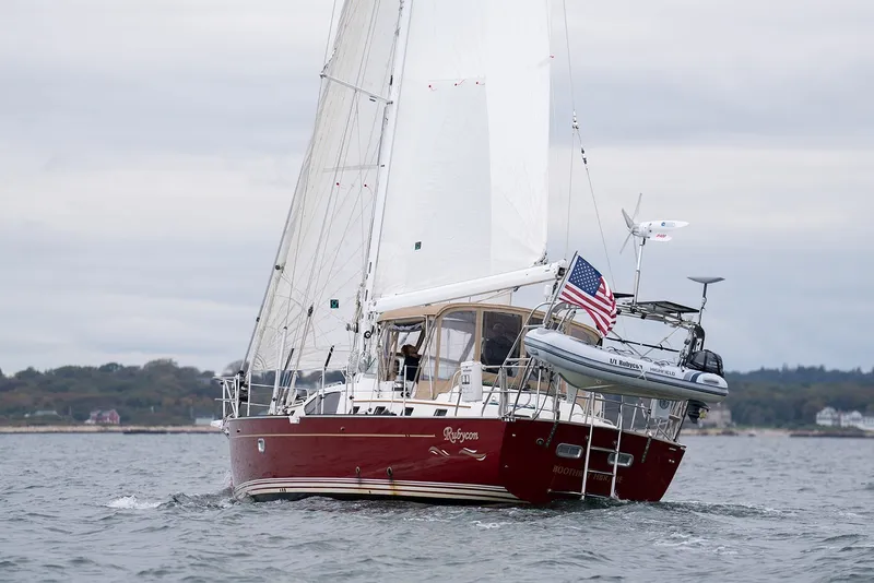 Slide: The Image of Sailing yacht Passport Vista 515 Center Cockpit, 2008, with American flag on open water. - 10