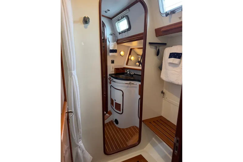 Slide: The Image of Luxurious bathroom interior of 2008 Passport Vista 515 Center Cockpit yacht, featuring wood accents. - 19