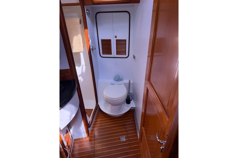 Slide: The Image of Bathroom interior of 2008 Passport Vista 515 Center Cockpit yacht, featuring wooden accents. - 20